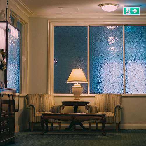 indoors turned-on table lamp living room